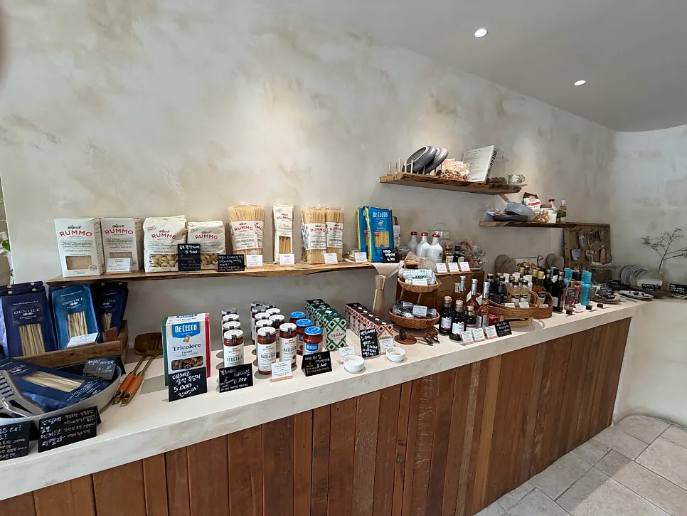 Imported pasta displayed on wooden shelves