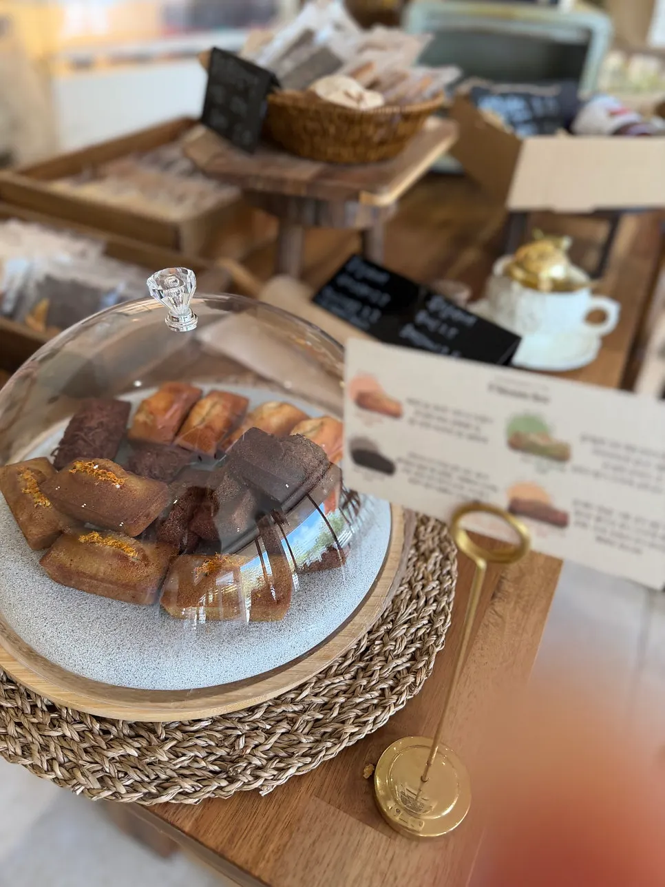 Financiers displayed under a glass dome