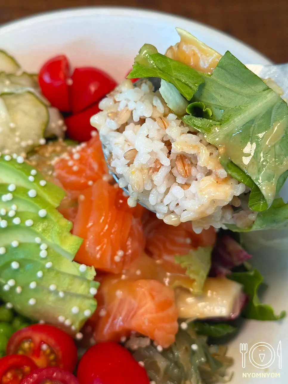 Grain salad topped with salmon and avocado