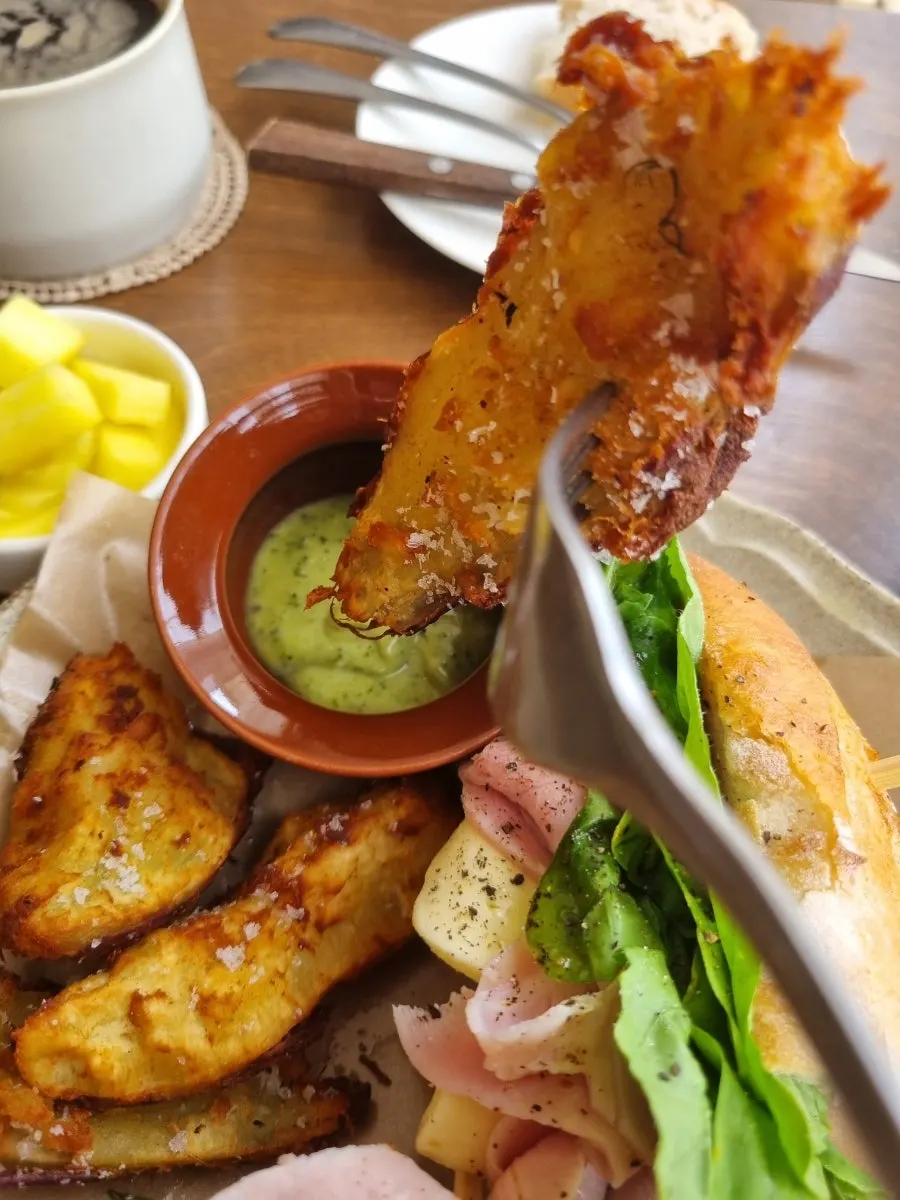 Fried sweet potato served alongside the sandwich