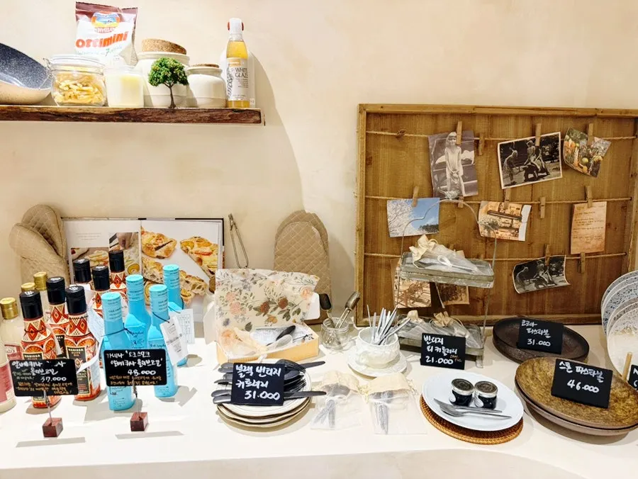 Grocery display of pasta noodles, jam, and oil