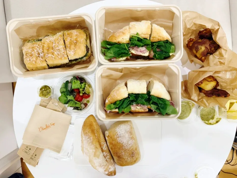 Mandali To Go takeout menu packed in paper bags
