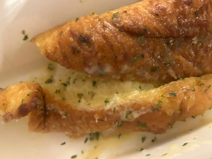 Cross-section of the garlic baguette showing garlic sauce soaked in