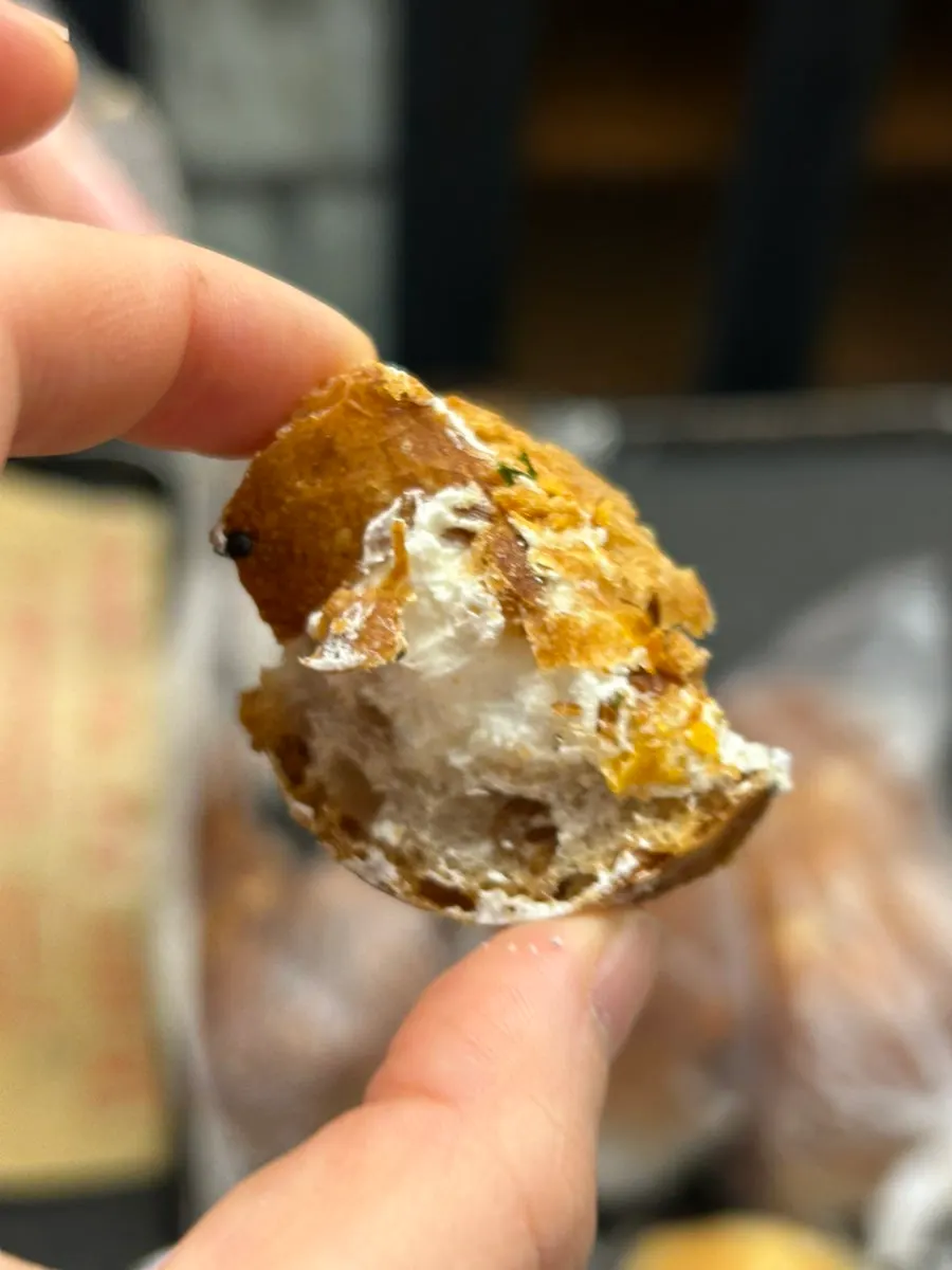 A sample piece of onion cream bagel