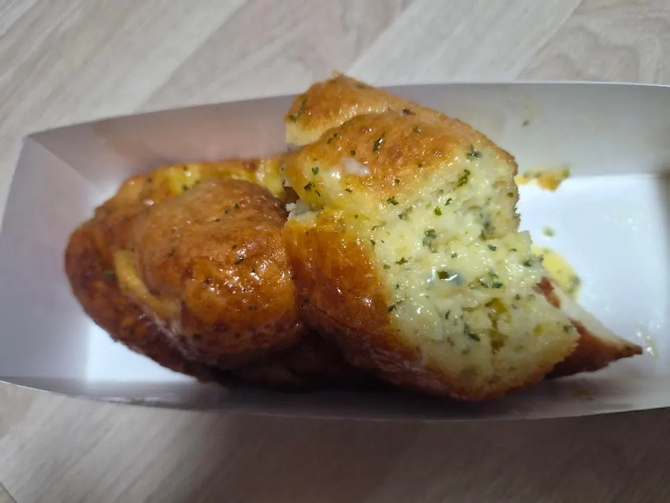 Cross-section of Mandong Jegwa's garlic baguette showing garlic sauce soaked through