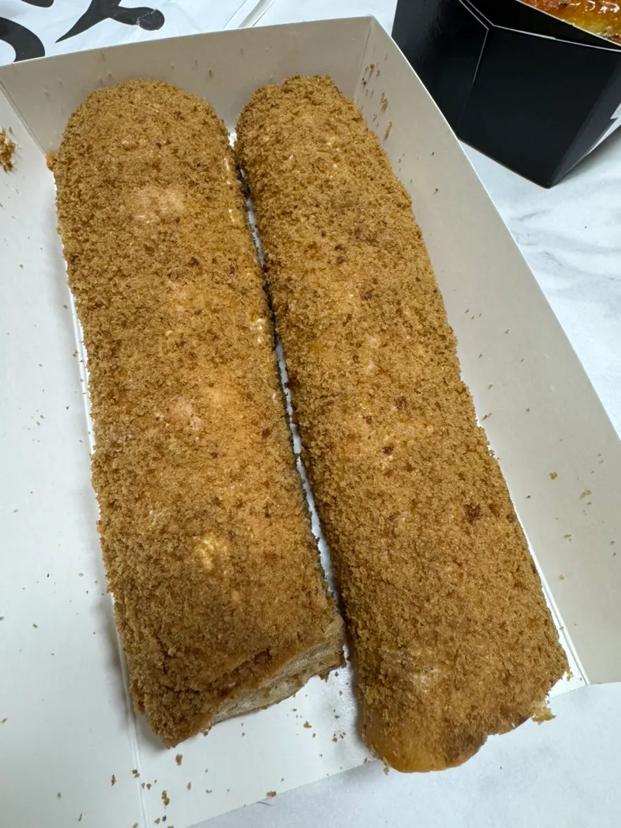 Cross-section of the garlic baguette with a piece torn off