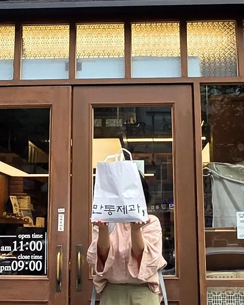 A heavy takeout bag holding 4 breads