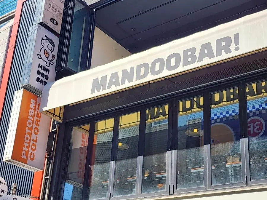 MANDOO BAR sign hanging above the 1F Photoism shop