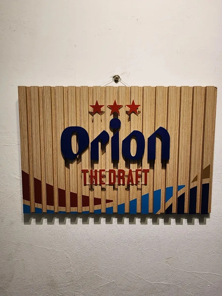 Wooden sign for Orion draft beer hanging on the wall