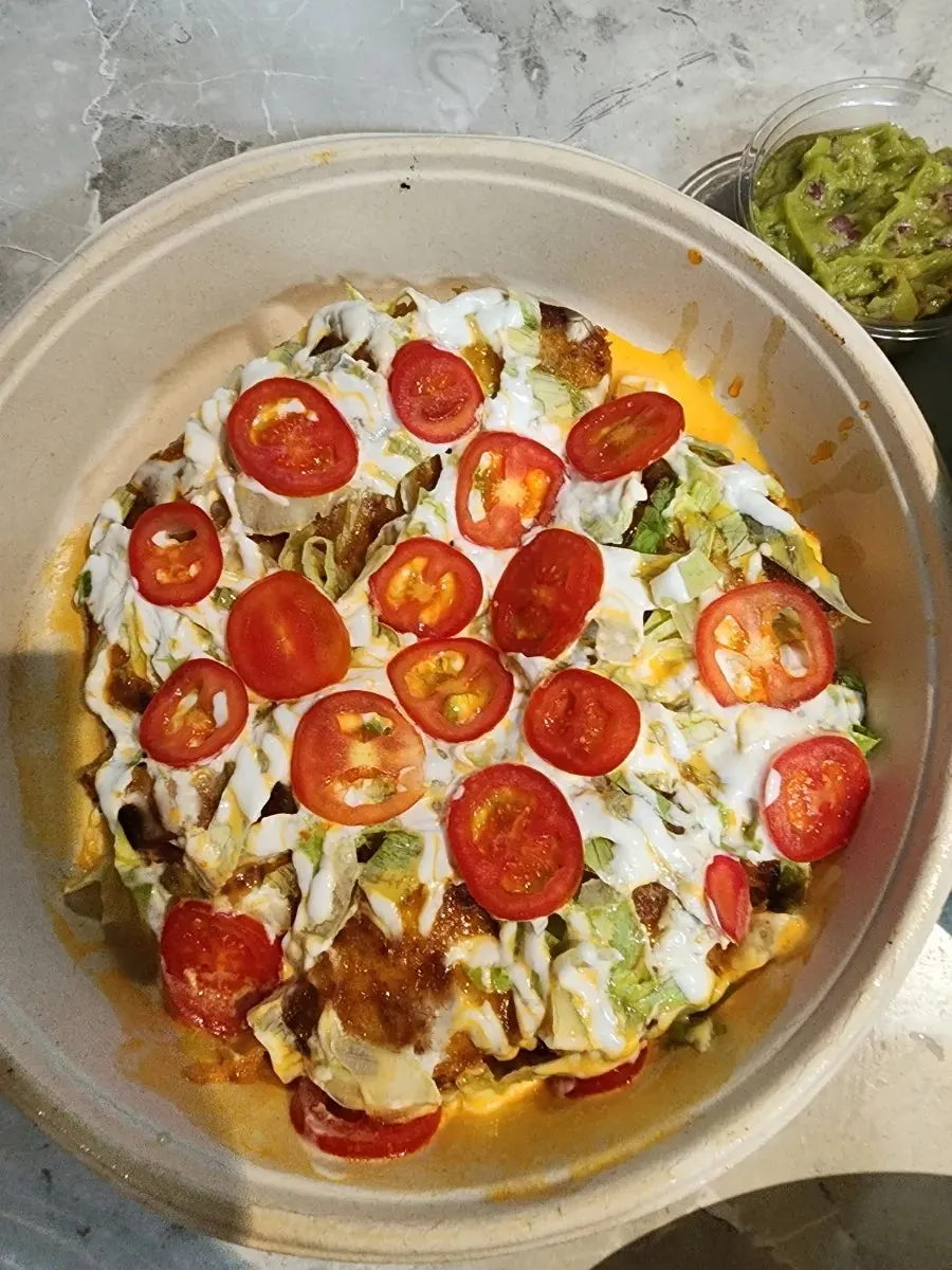 Mexican taco gyoza topped with guacamole and nachos