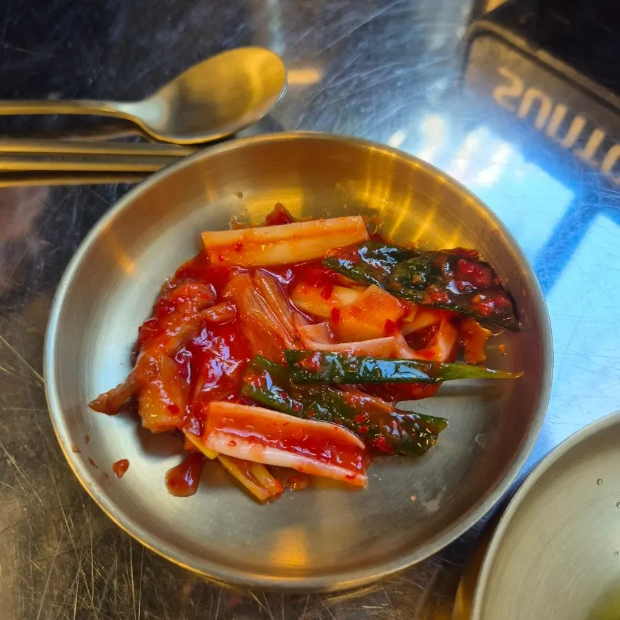 Side dishes including pickled onions and myeongi-namul, gopchang's usual companions