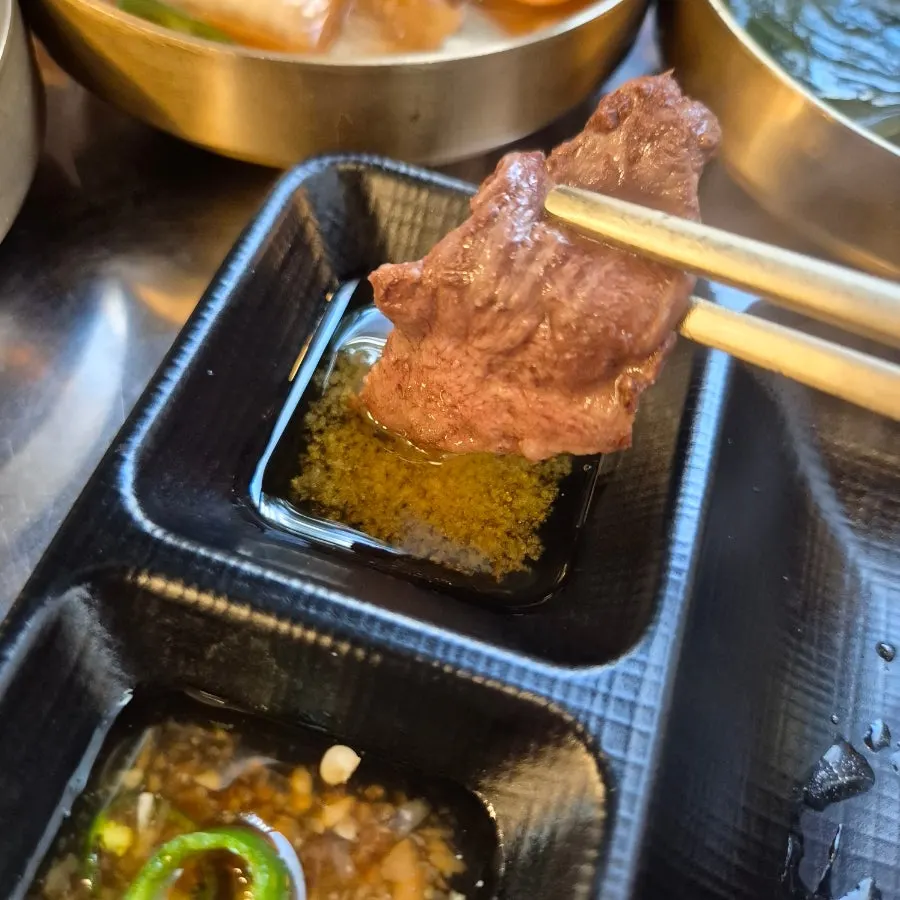 A well-grilled piece of gopchang packed with fat