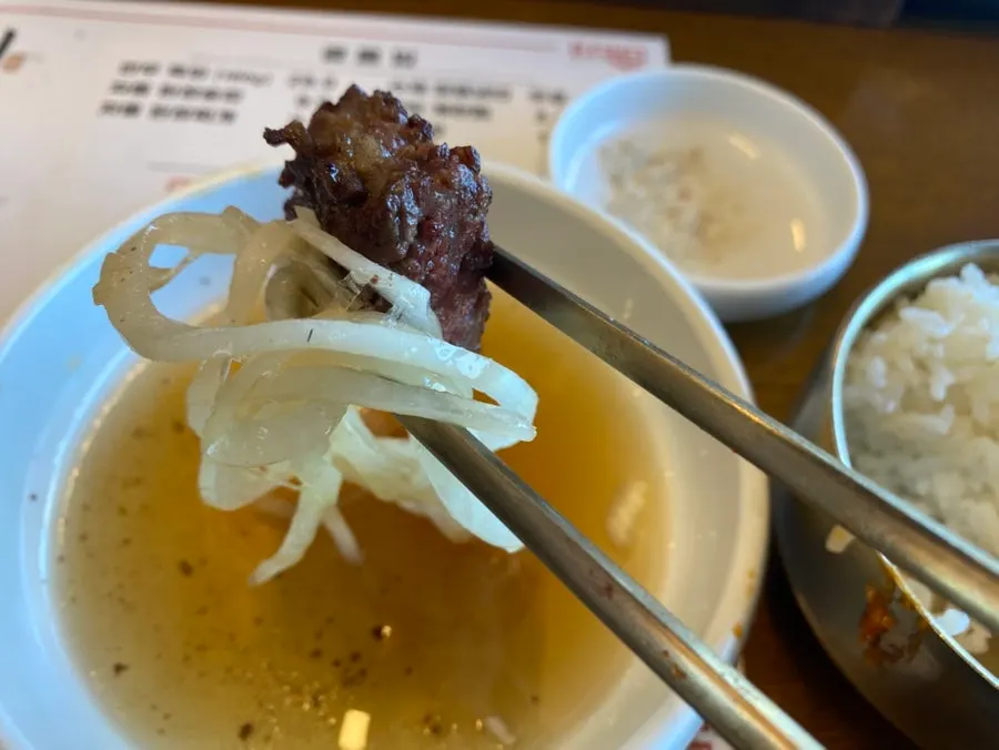 First bite of beef short rib dipped in salt
