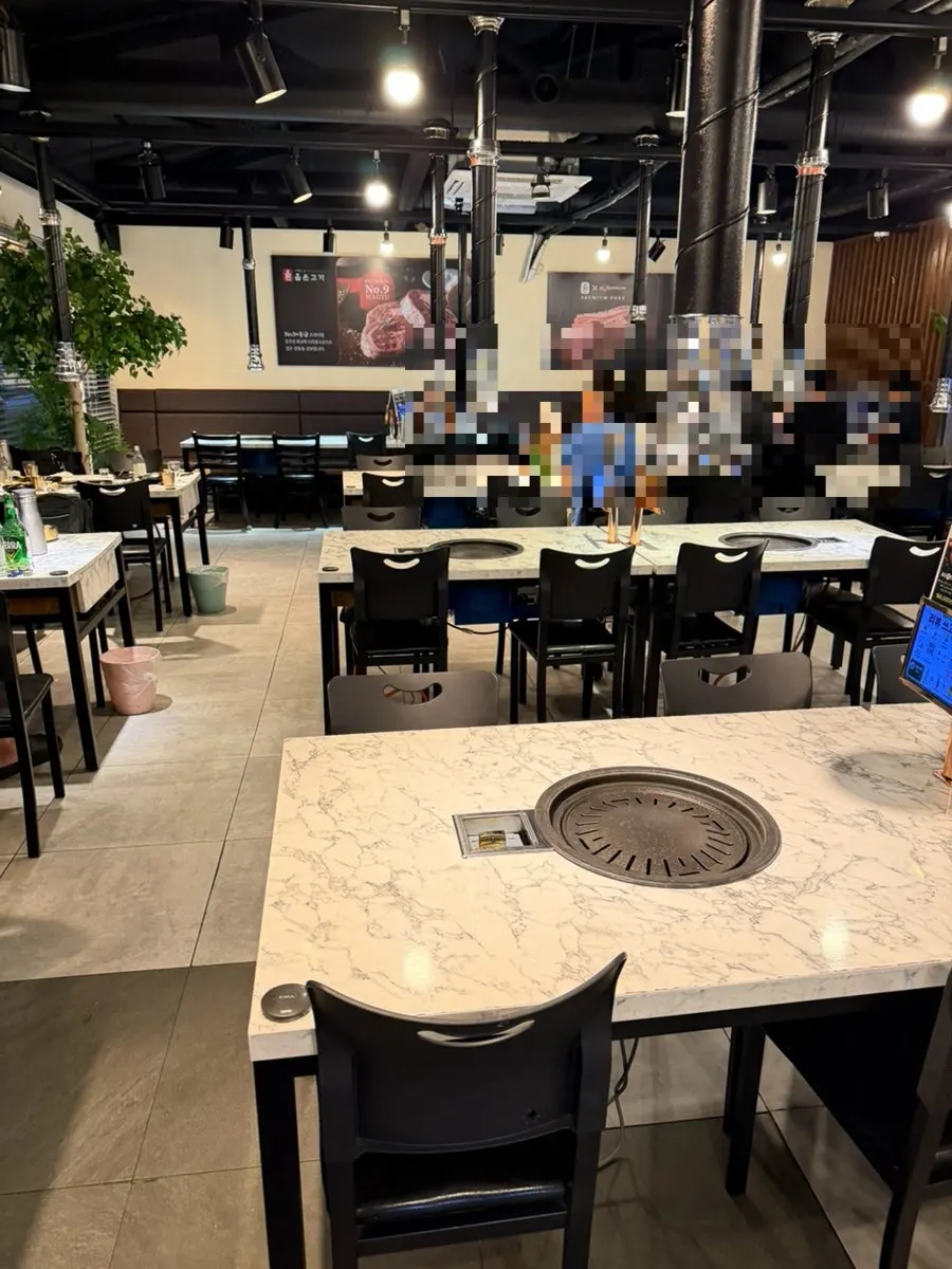 Dining hall seating with roaster hoods at Olheun Gogi Suwon Main Branch