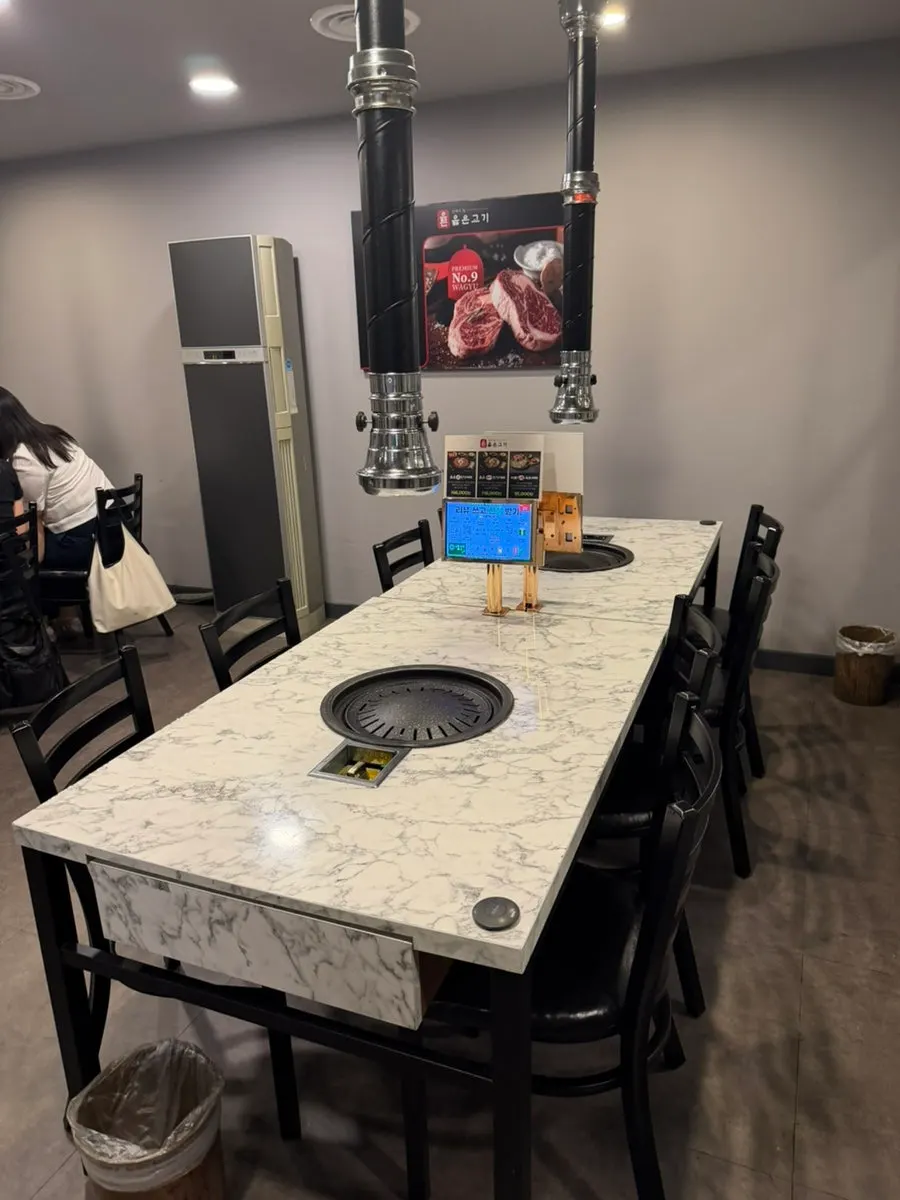 Spacious dining hall with grill tables