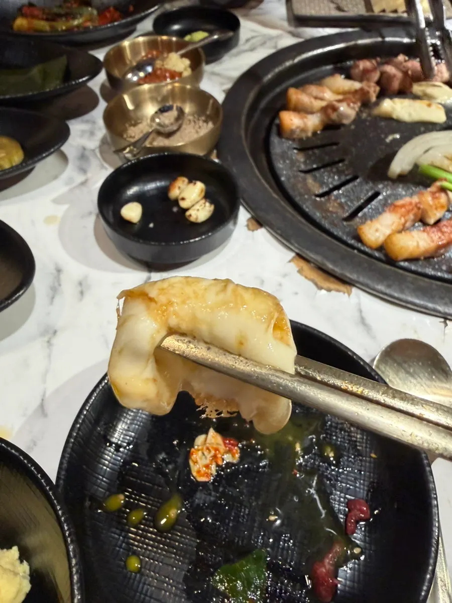 A wrap of myeong-i namul and meat