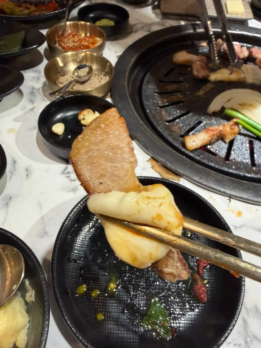 Sliced cheese melting on the grill