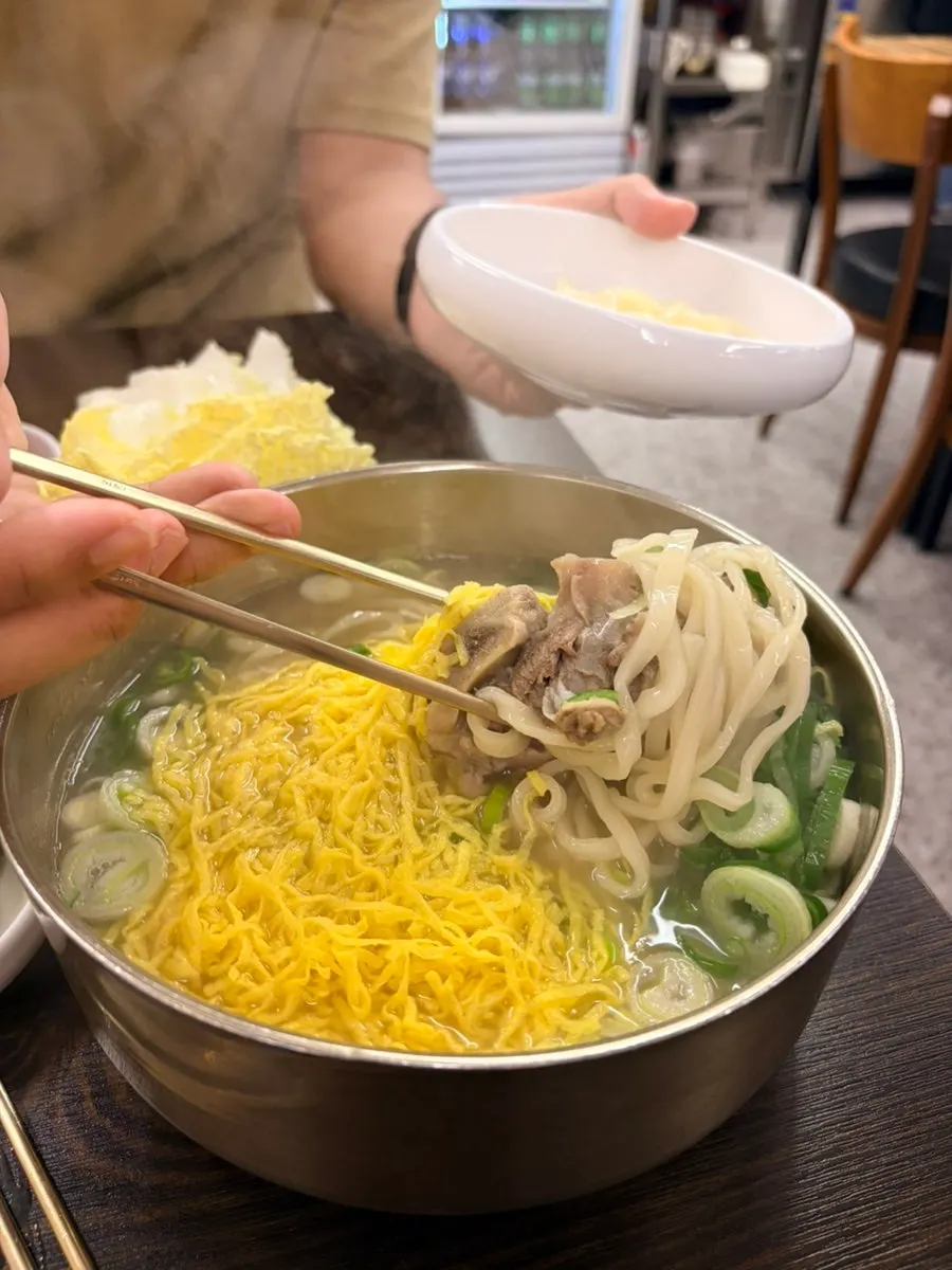 Bone kalguksu with two bone chunks inside