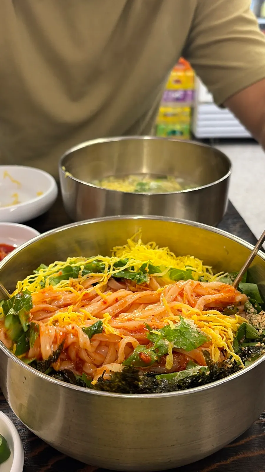 Bibim kalguksu topped with sauce, ready to mix