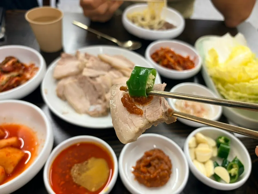 A two-person spread of bossam and kalguksu together