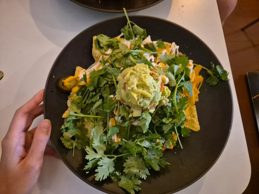 Cilantro nachos with guacamole mounded in the center