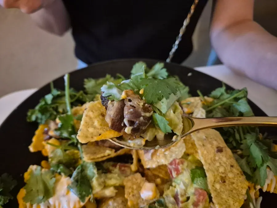 Two plates of nachos on the table