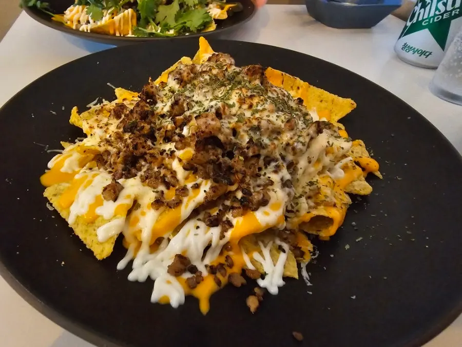 Nacho chips crushed and mixed with sauce