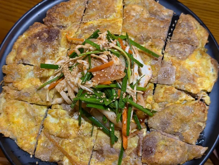 Yukjeon plate topped with chive salad