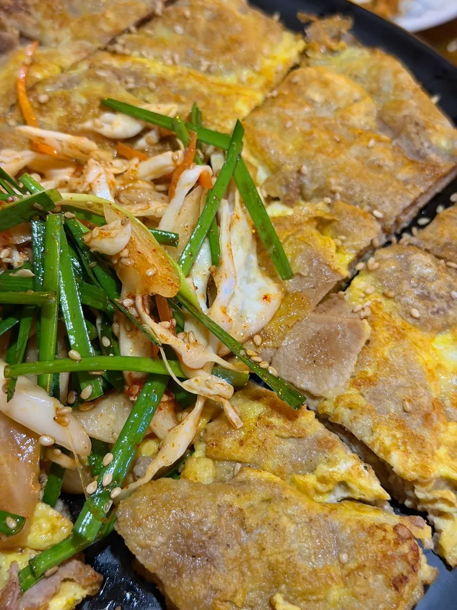 Vertical close-up of golden pan-fried yukjeon