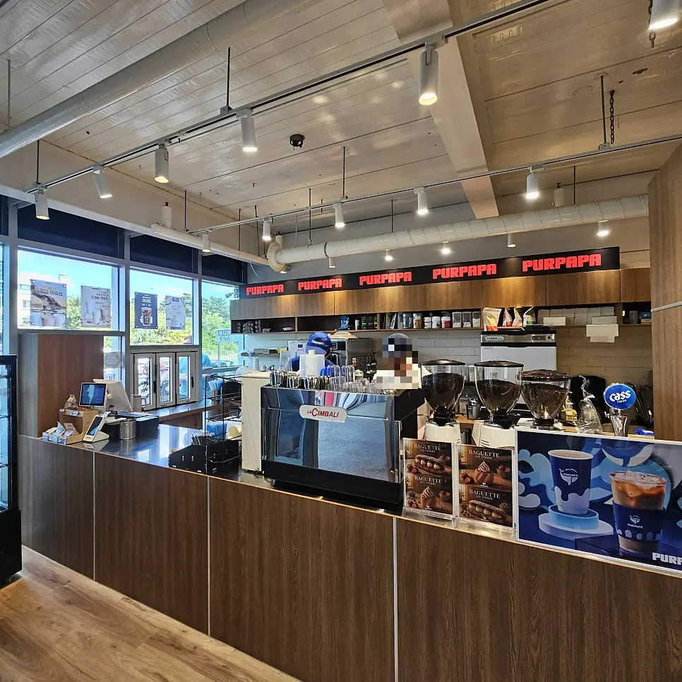 Interior with a long counter and espresso machine