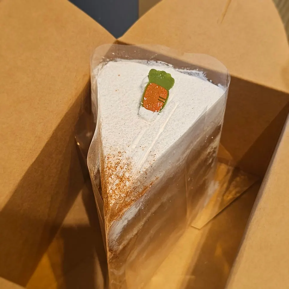 Carrot cake with a carrot decoration and multiple layers