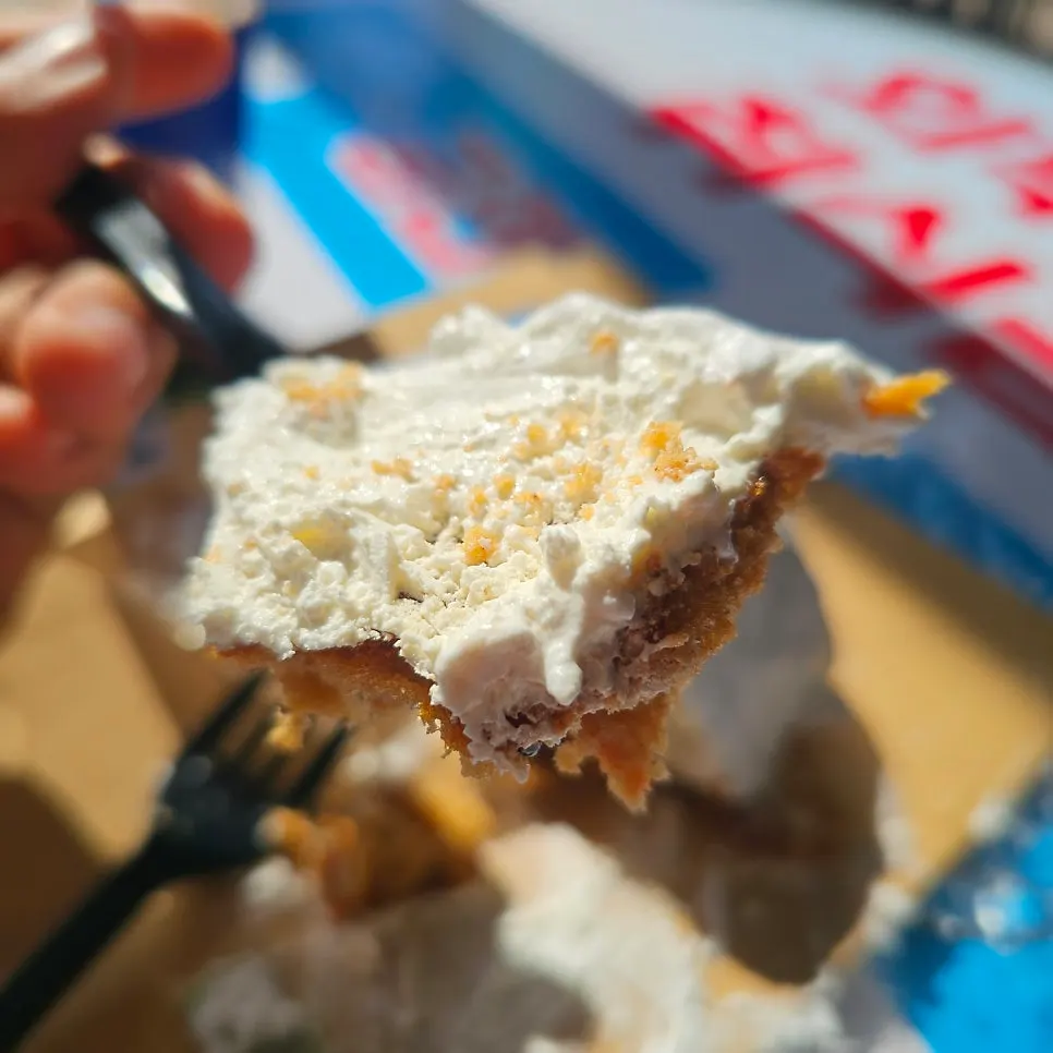 Cross-section of carrot cake showing cream and cake layers