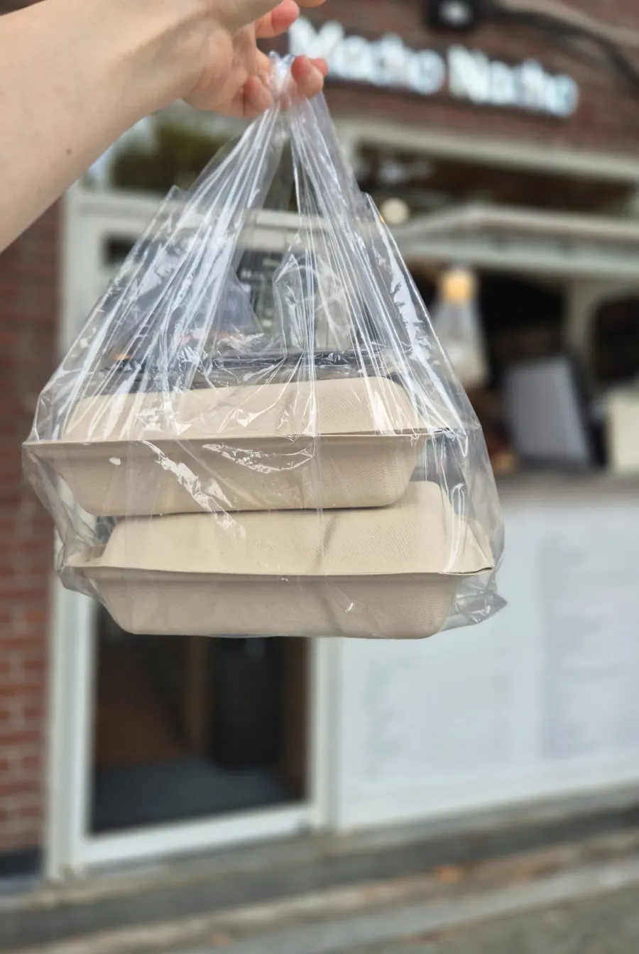 Takeout container of Macho Nacho's nachos