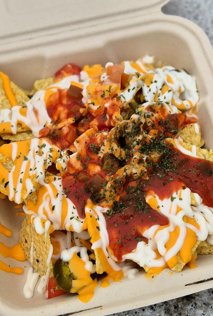 Opening the takeout box of Macho Nacho by the Han River
