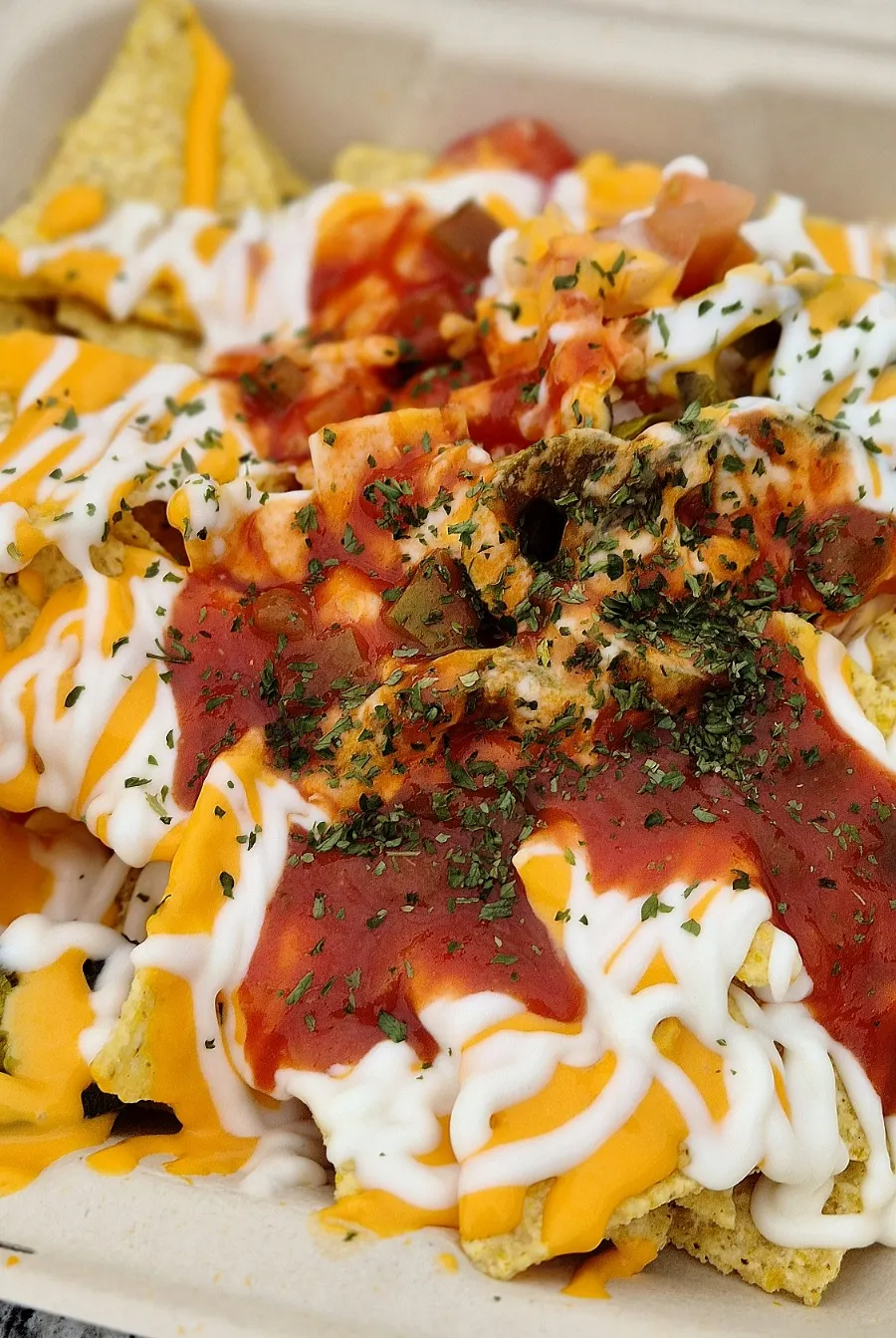 Loading toppings onto a nacho chip