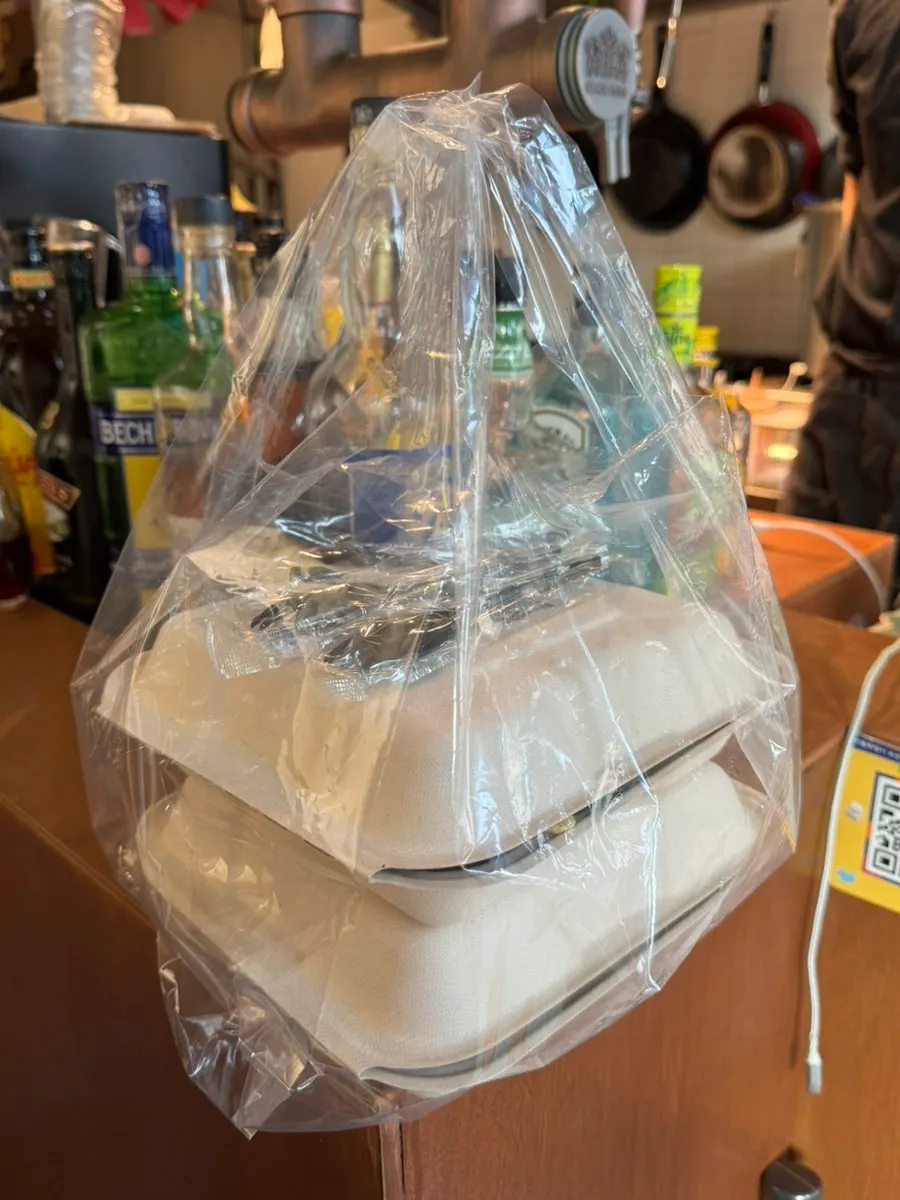 Takeout bag with packed nachos
