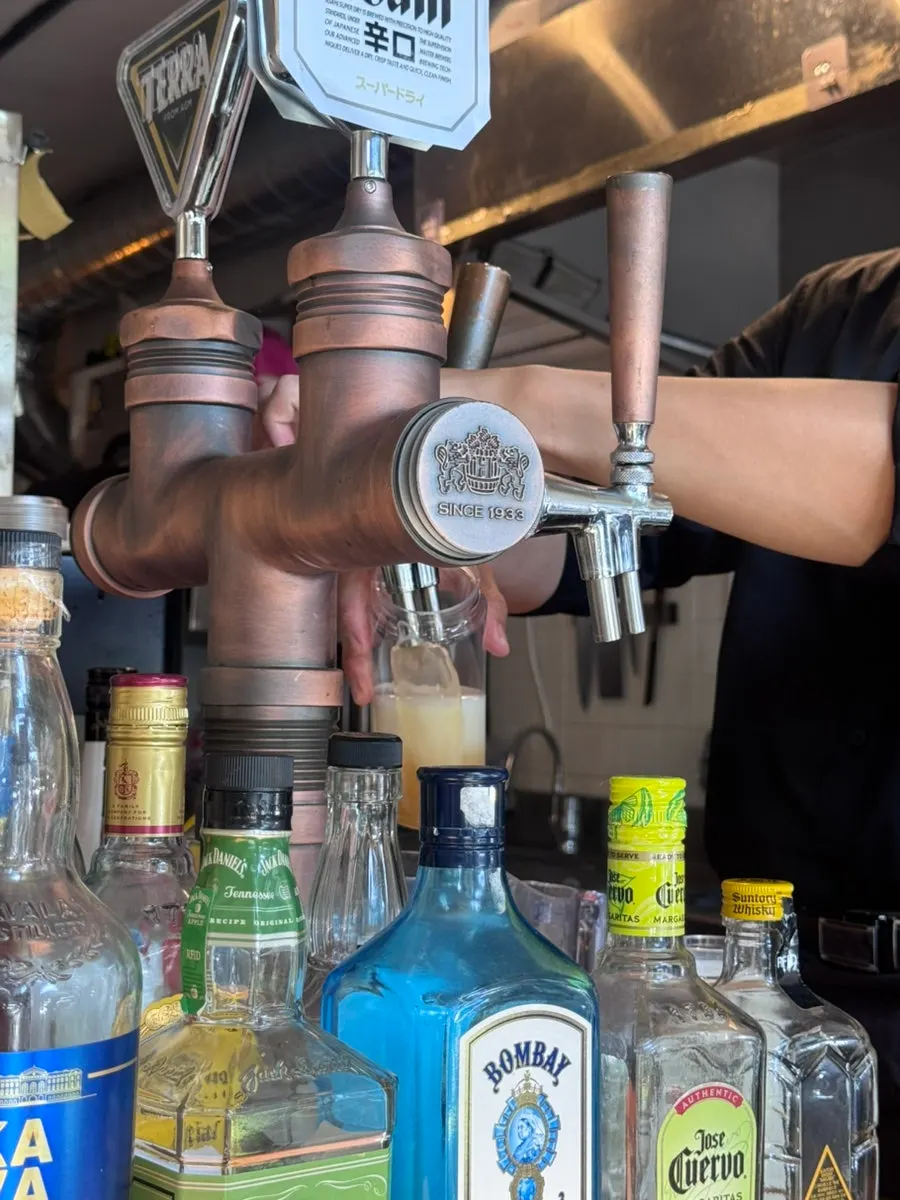 Draft beer being prepared for takeout at Macho Nacho
