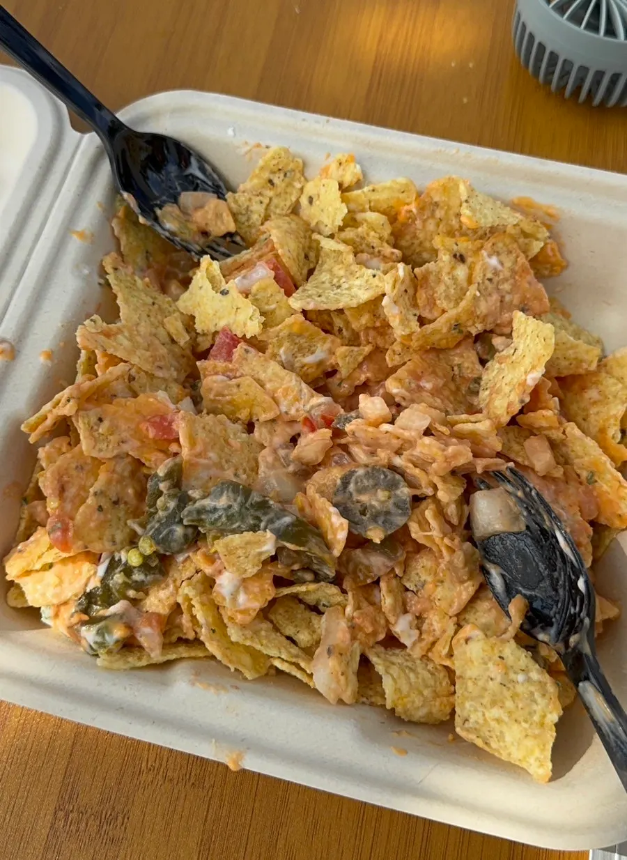 Macho Nacho nachos topped with toppings and sauce