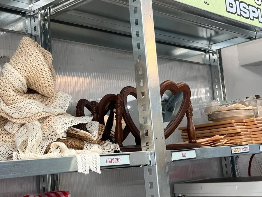 Picnic mats in various colors displayed with other picnic gear