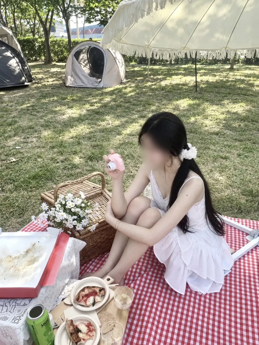 Holding a rented wildflower bouquet for a picnic photo