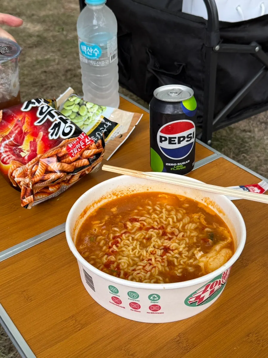 Ramen and snack setup on the Han River picnic table