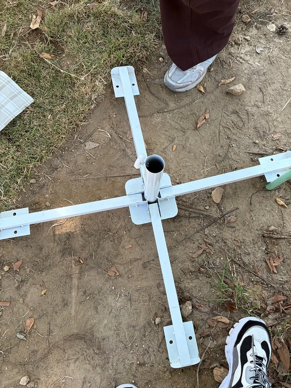 Rental parasol laid out in disassembled pieces