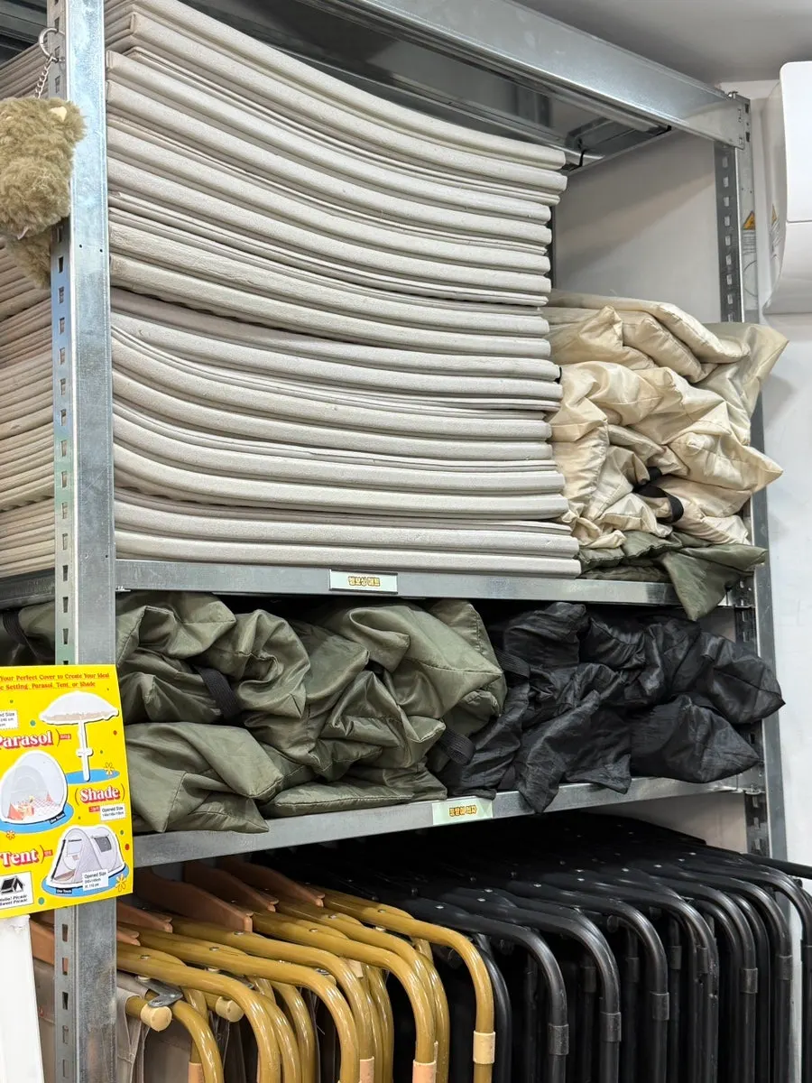 Tents and mats arranged on the rental shop shelves