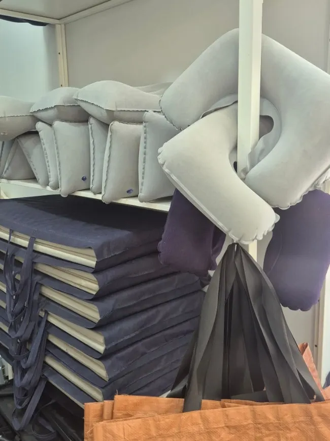 Rental corner with pillows and different types of camping chairs