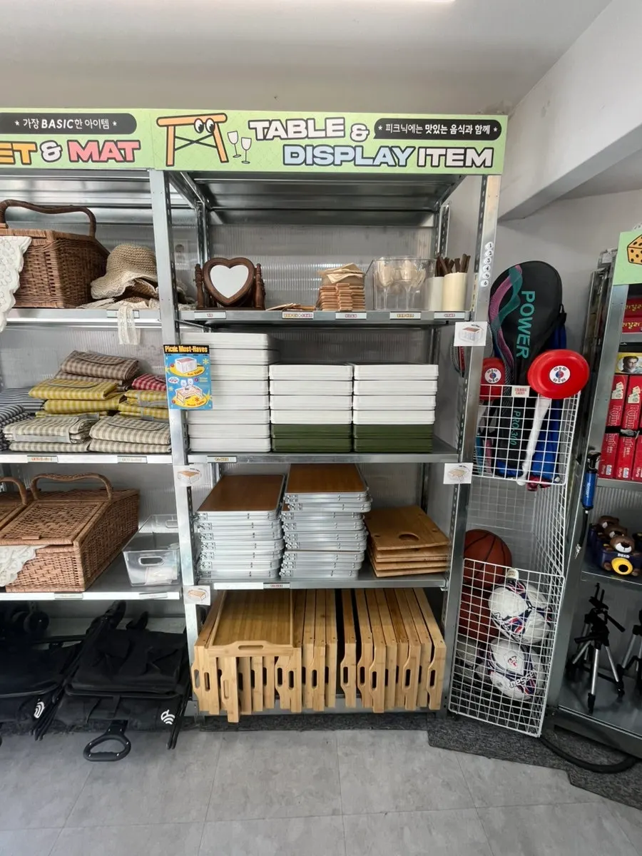 Display shelf of wine glasses, tableware, and picnic props
