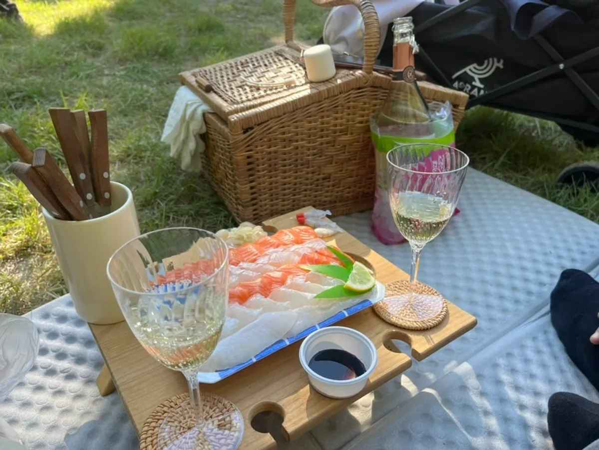 Sashimi and white wine picnic spread on the embossed mat
