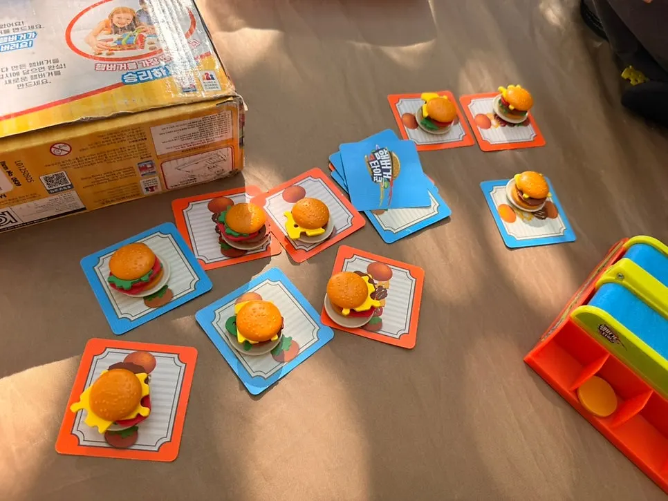 Burger Tycoon board game with a moving conveyor rail