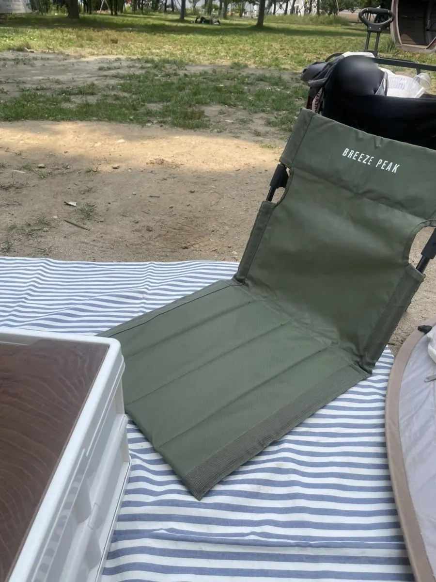 Mat and comfortable picnic chair set up inside the tent