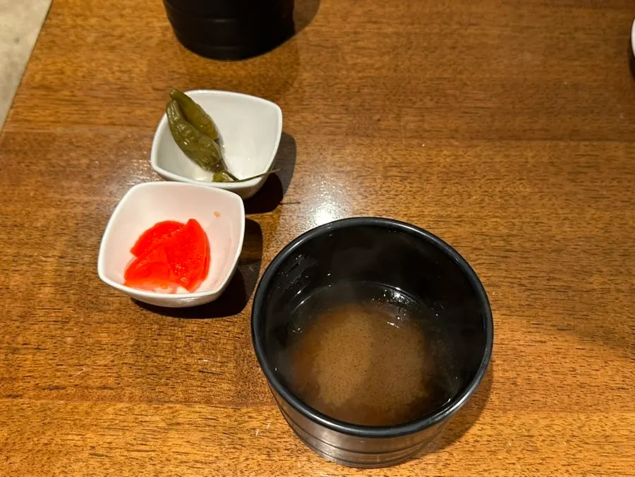 Clear soup, pickled radish, and pickled chili side dishes