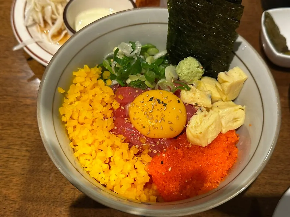 Tuna rice bowl topped with flying fish roe and rolled egg